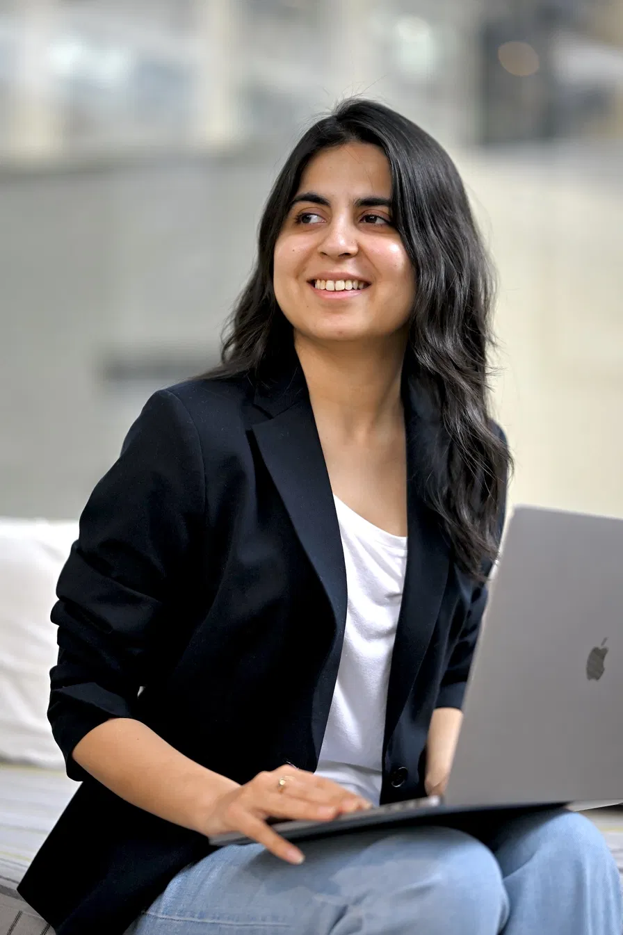 Twinkle Mohan working on a laptop